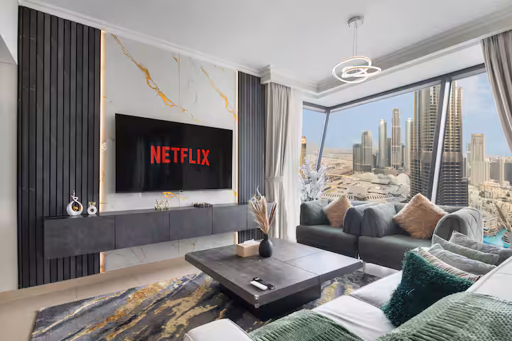 Burj Vista: The living room, the sofa facing the television, the Burj Khalifa in the window