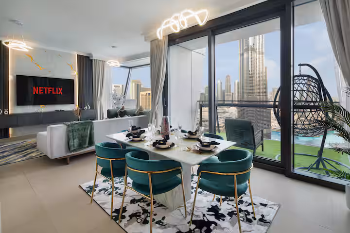 Burj Vista: The dining table for four at the window, green velvet chairs