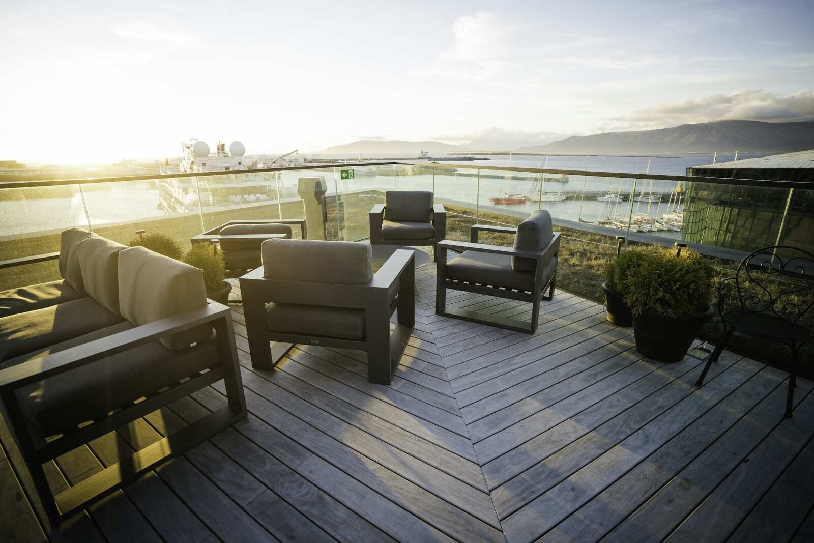 Lounge chairs on a wooden terrace in the evening sun
