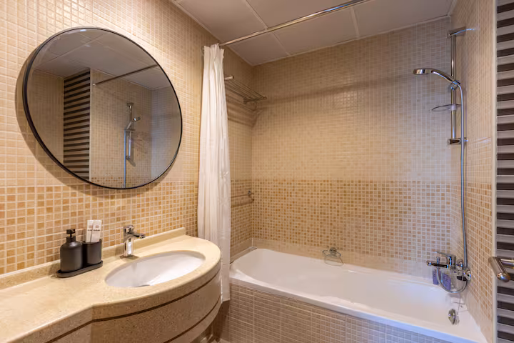 Sulafa Tower: A bathroom in mosaic tile, with a bath
