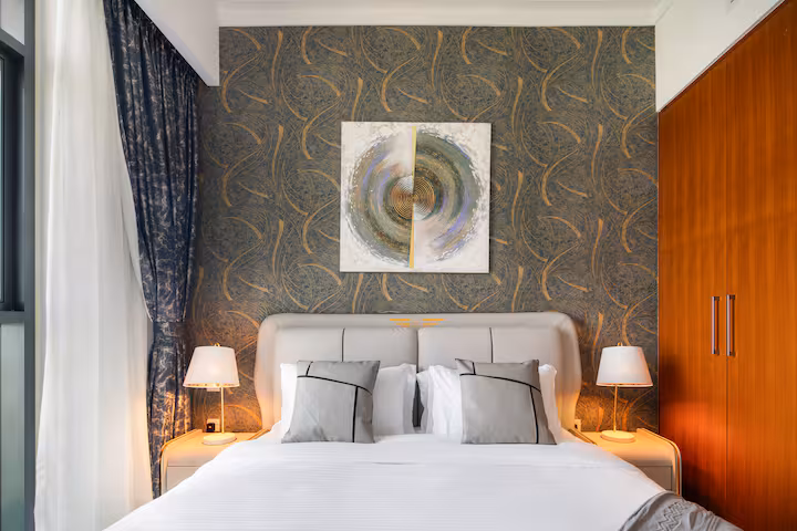 Vida Residences: Bedroom two, the television on the wall