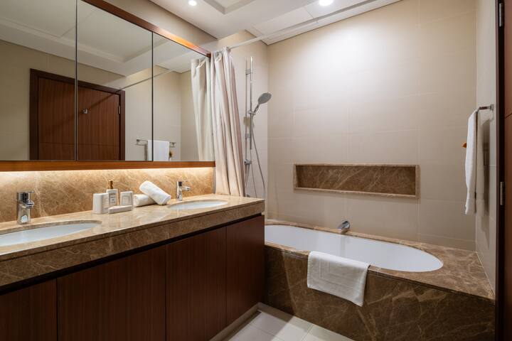 Vida Residences: Bathroom one, a bath and a walk-in shower